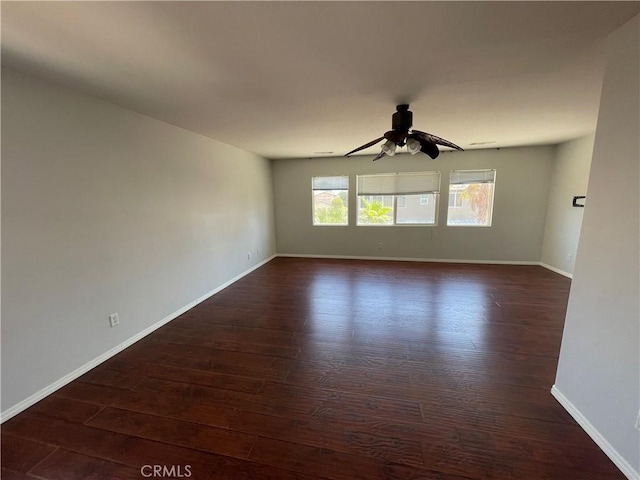 spare room featuring ceiling fan and dark hardwood / wood-style flooring