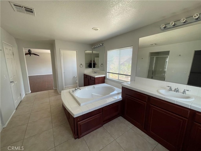 bathroom with tile patterned flooring, ceiling fan, a textured ceiling, and vanity