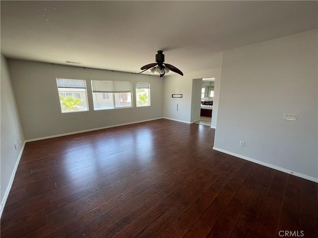 spare room with dark hardwood / wood-style floors and ceiling fan