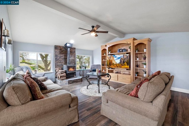 living room with plenty of natural light, a wood stove, and dark wood-type flooring