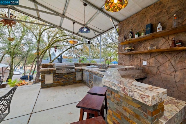 view of patio / terrace with area for grilling and sink