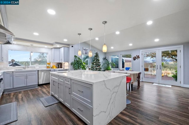 kitchen featuring gray cabinets, a wealth of natural light, dishwasher, and a kitchen island