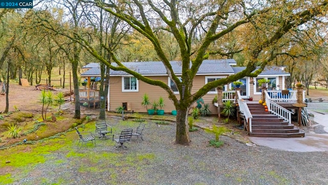 back of house featuring a deck