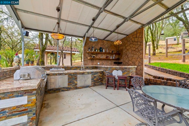 view of patio with area for grilling, grilling area, and sink