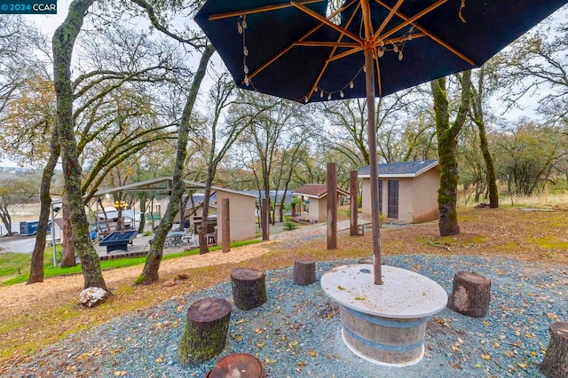 view of patio / terrace featuring an outbuilding