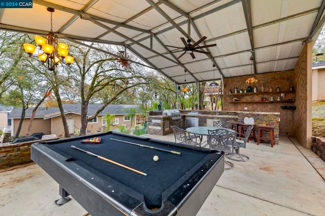 playroom featuring vaulted ceiling, concrete flooring, ceiling fan with notable chandelier, and billiards