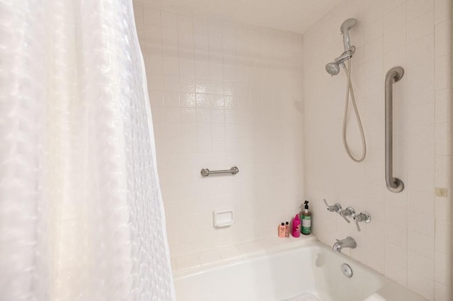 bathroom with shower / bath combo with shower curtain