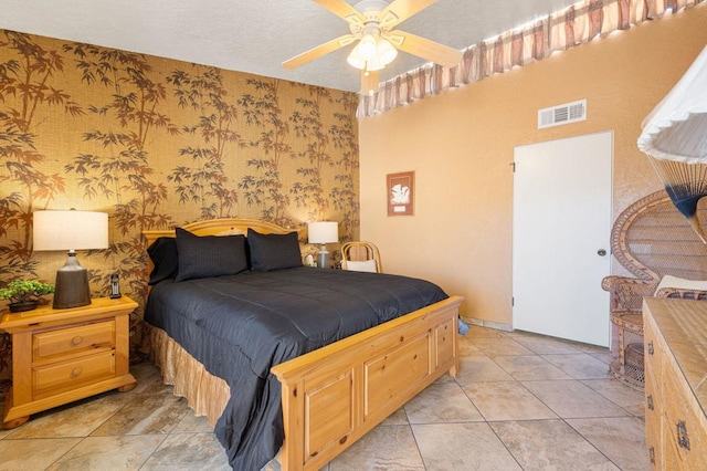 bedroom with ceiling fan and light tile patterned floors