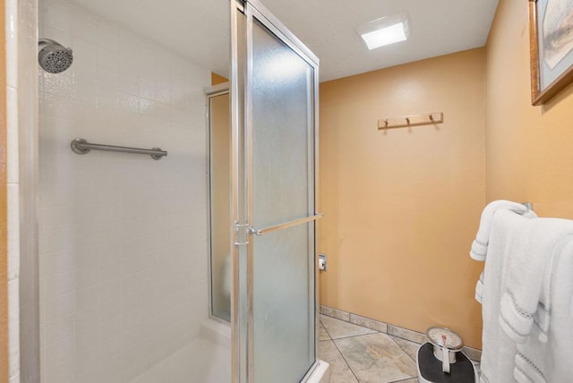 bathroom featuring an enclosed shower and tile patterned flooring