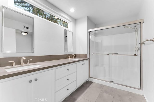 bathroom with vanity, tile patterned floors, and a shower with shower door