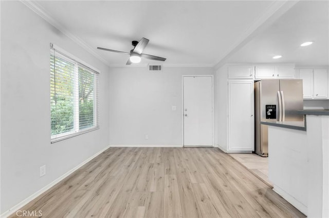 unfurnished living room with ceiling fan, light hardwood / wood-style flooring, and ornamental molding