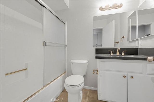 full bathroom with tile patterned floors, vanity, enclosed tub / shower combo, and toilet