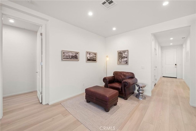 sitting room featuring light hardwood / wood-style flooring