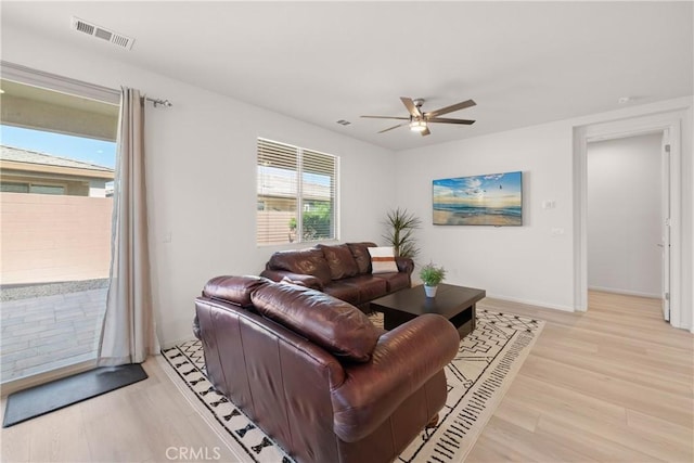 living room with ceiling fan and light wood-type flooring