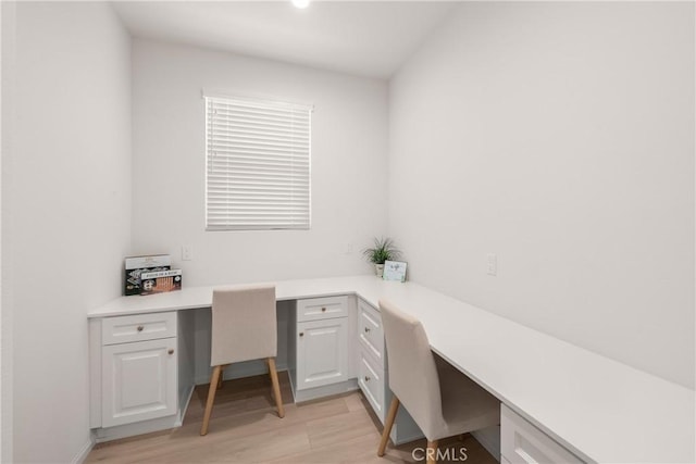 office area featuring built in desk and light wood-type flooring