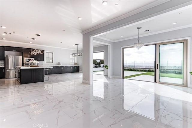 kitchen with a center island, marble finish floor, light countertops, an inviting chandelier, and freestanding refrigerator