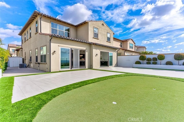 rear view of house with central AC unit, a patio, a tile roof, fence, and stucco siding