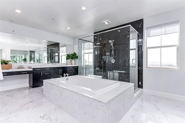 full bathroom with marble finish floor, a stall shower, vanity, and a wealth of natural light