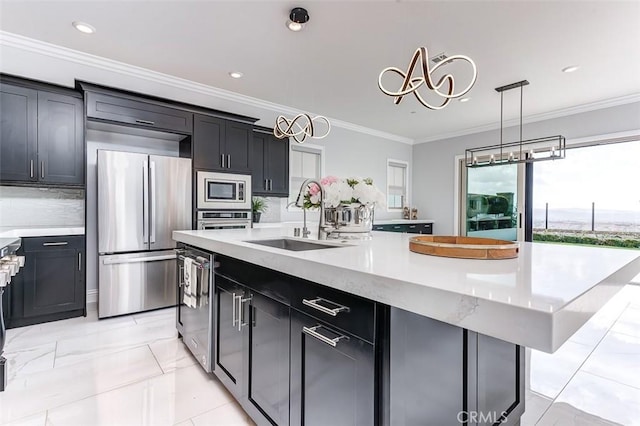 kitchen featuring stainless steel appliances, backsplash, ornamental molding, a sink, and a large island with sink