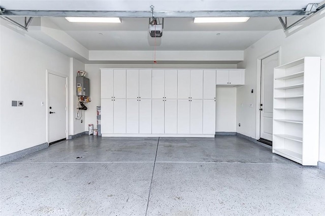 garage featuring water heater, baseboards, and a garage door opener