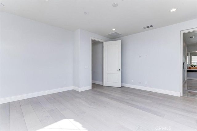 unfurnished bedroom with light wood-style flooring, visible vents, baseboards, and recessed lighting