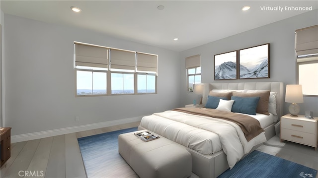 bedroom with recessed lighting, baseboards, and wood finished floors