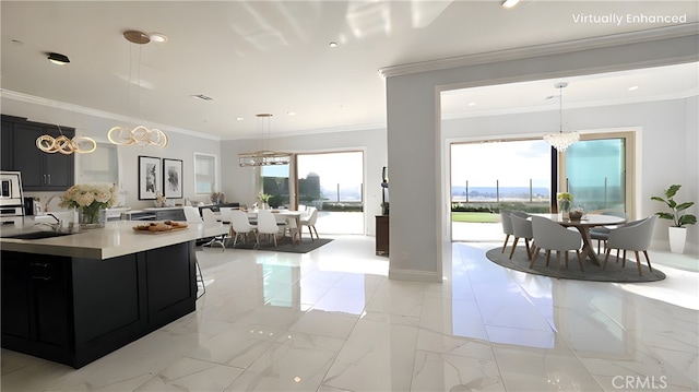 kitchen with an inviting chandelier, marble finish floor, a wealth of natural light, and dark cabinetry