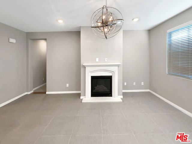 unfurnished living room with light tile patterned flooring and a chandelier