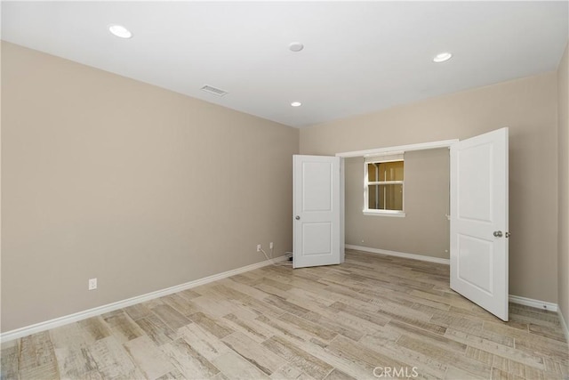 unfurnished bedroom with light wood-type flooring