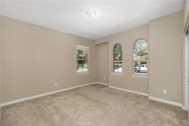 spare room with light colored carpet