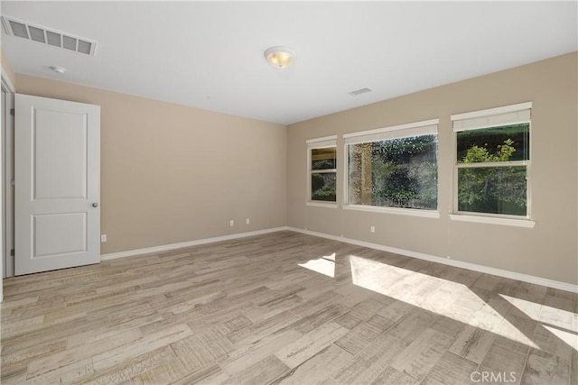 empty room with light hardwood / wood-style floors