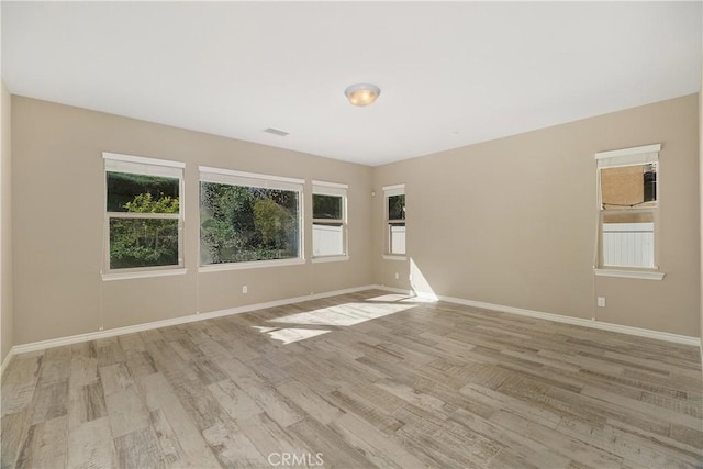 unfurnished room with light wood-type flooring