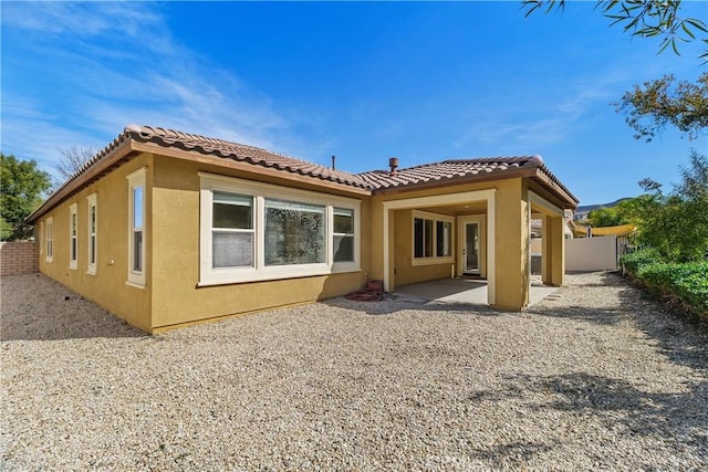 rear view of property featuring a patio area