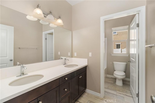 bathroom featuring toilet and vanity
