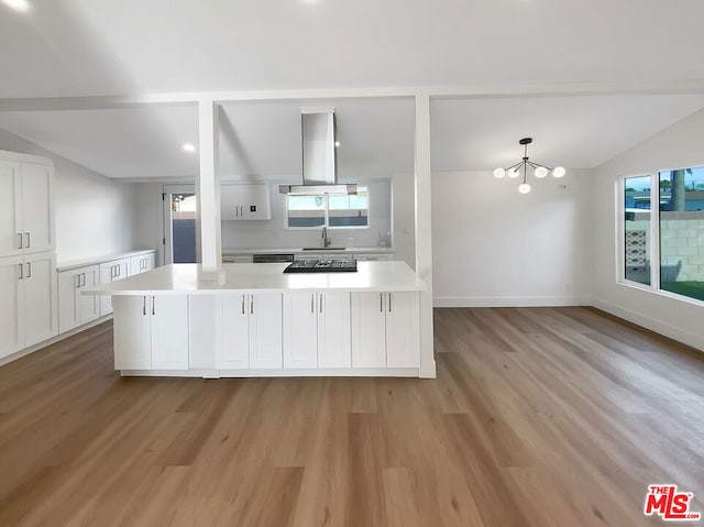 kitchen featuring light hardwood / wood-style flooring, extractor fan, a wealth of natural light, and lofted ceiling