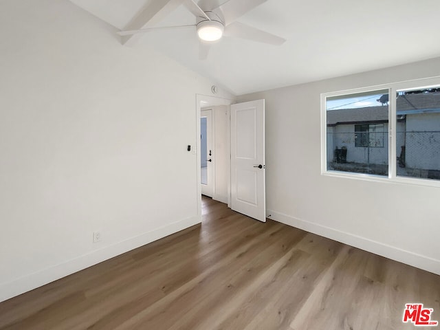 spare room with ceiling fan, hardwood / wood-style floors, and vaulted ceiling