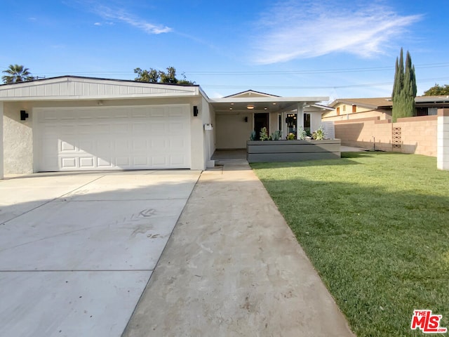 ranch-style house with a garage and a front lawn