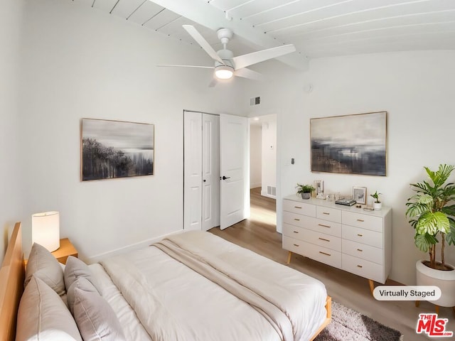 bedroom with a closet, vaulted ceiling, ceiling fan, and dark wood-type flooring