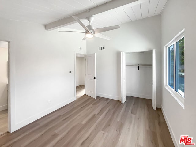 unfurnished bedroom with ceiling fan, light hardwood / wood-style flooring, beamed ceiling, and high vaulted ceiling