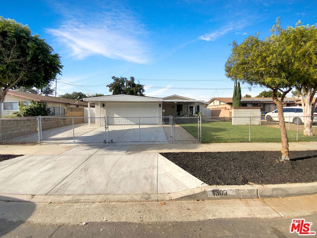 ranch-style house featuring a front yard and a garage