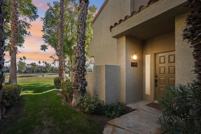 exterior entry at dusk with a yard