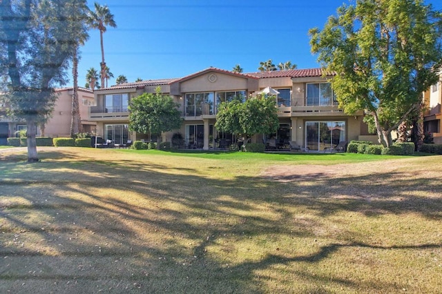 rear view of house featuring a yard