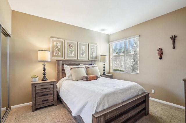 bedroom with light colored carpet and a closet