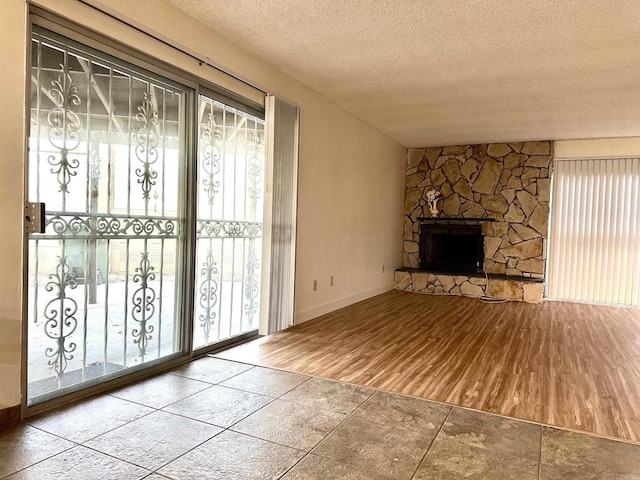 unfurnished living room featuring a textured ceiling and a fireplace