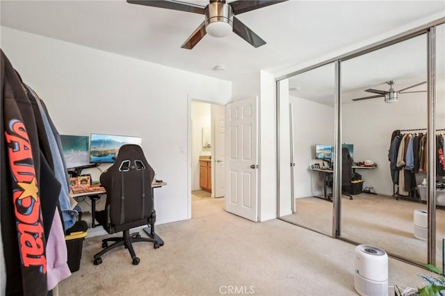 office space featuring ceiling fan and light colored carpet