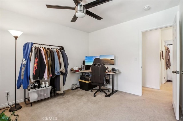 carpeted office space with ceiling fan