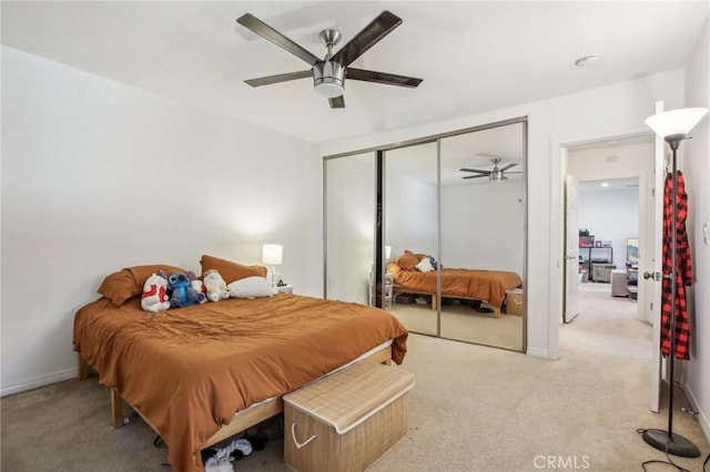 carpeted bedroom featuring ceiling fan and a closet