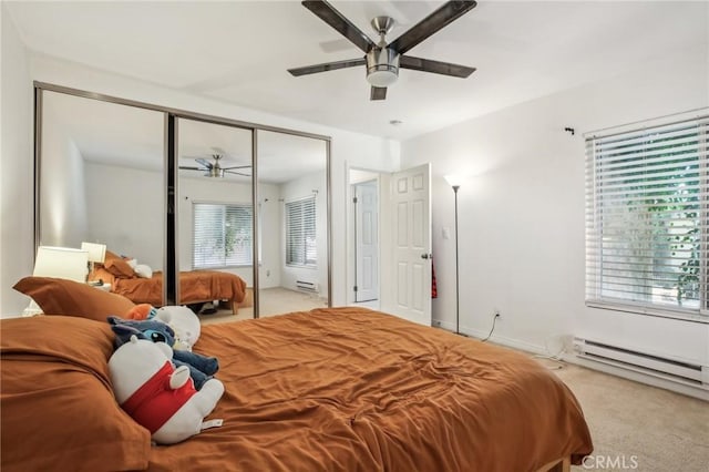 carpeted bedroom featuring ceiling fan, a closet, and a baseboard radiator