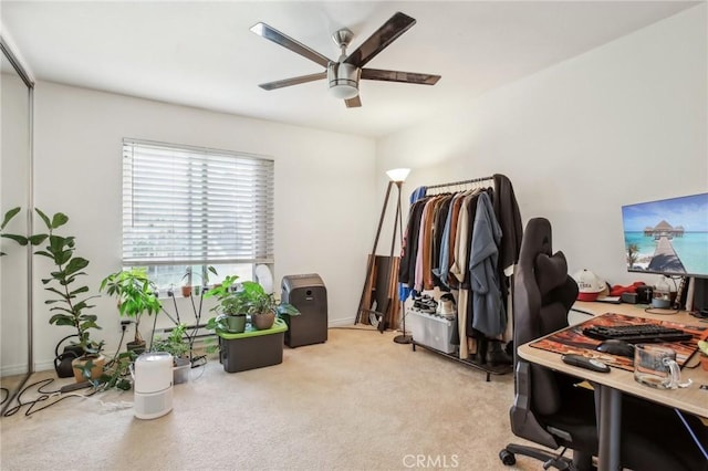 carpeted office space with ceiling fan