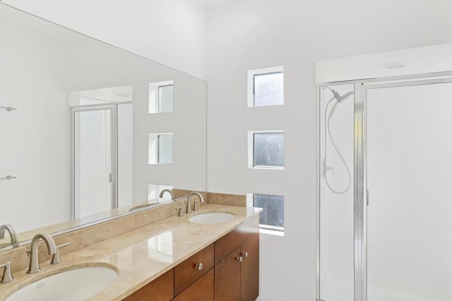 bathroom featuring an enclosed shower and vanity